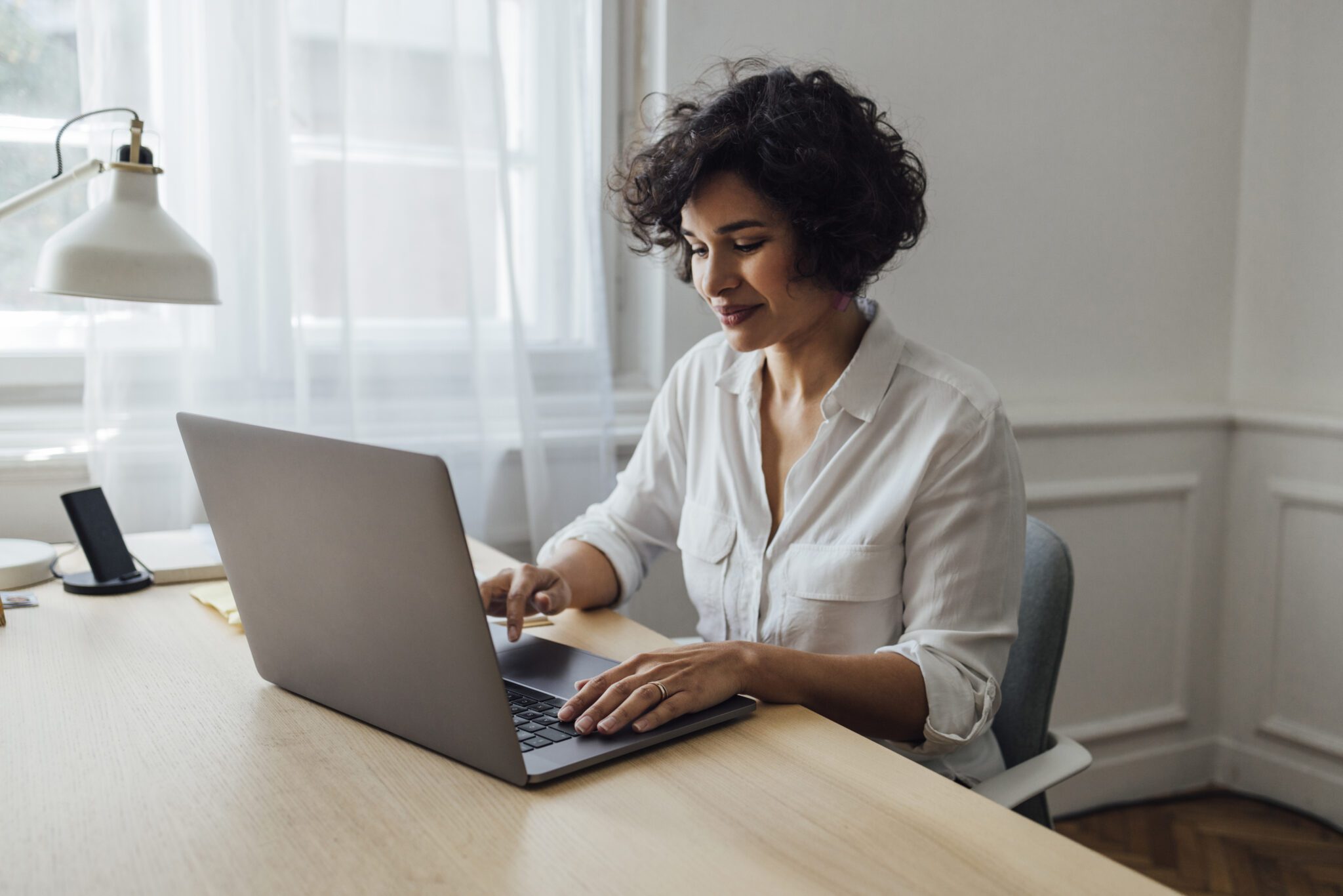 A Beautiful African-American Female Working Online On Her Laptop