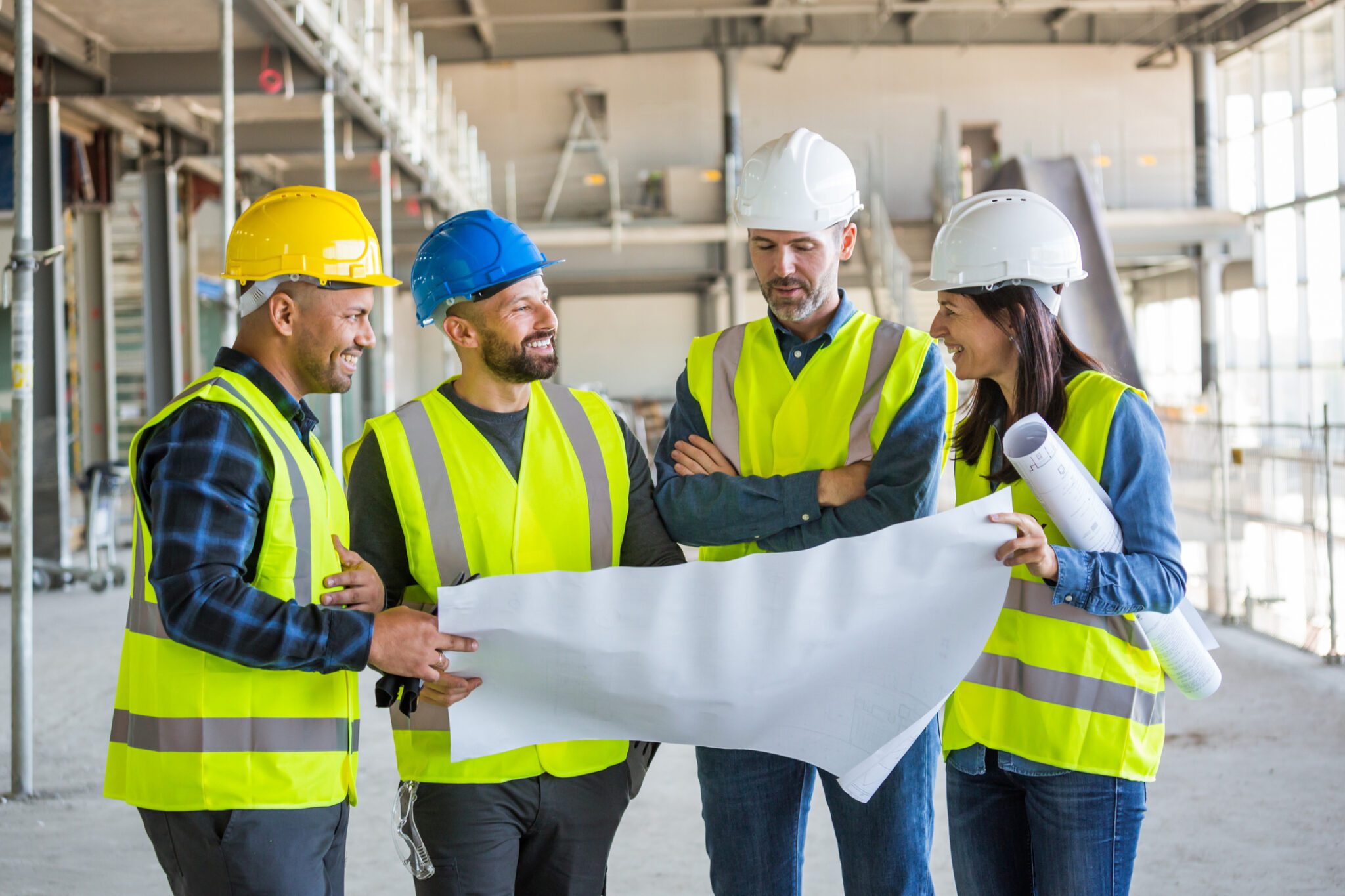 Architects talking with team at an indoor construction site