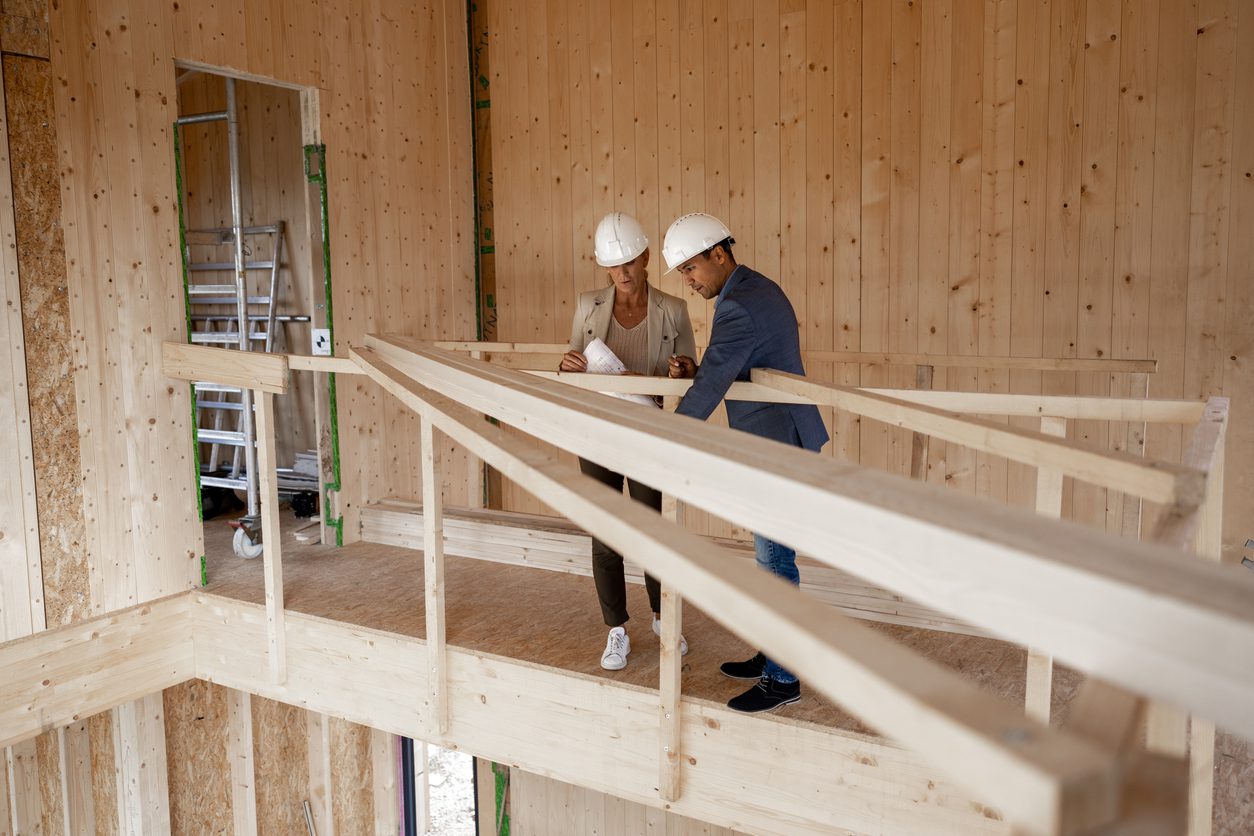 The inspector and the foreman are checking the works on the house