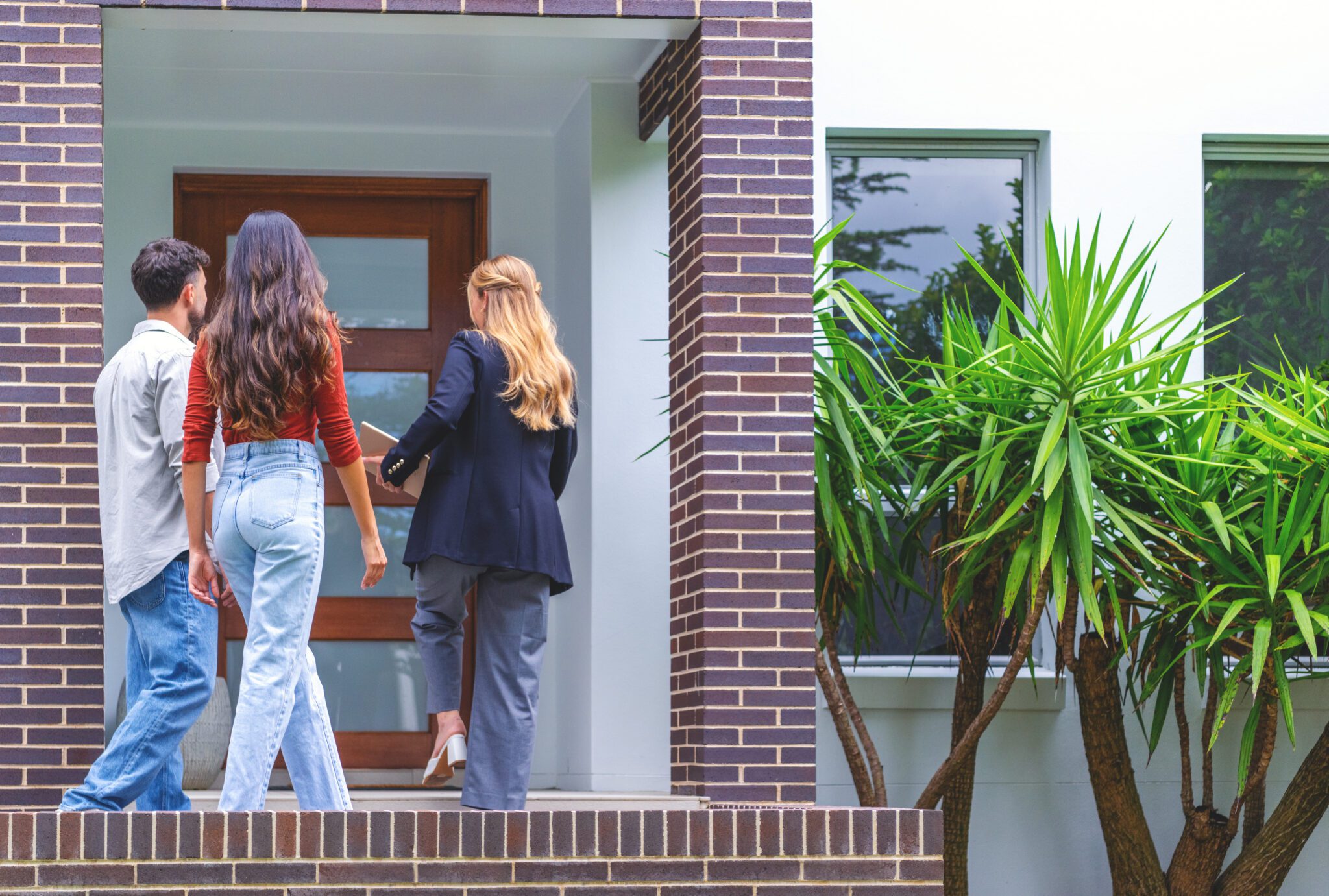 Real estate agent showing a couple a new house.