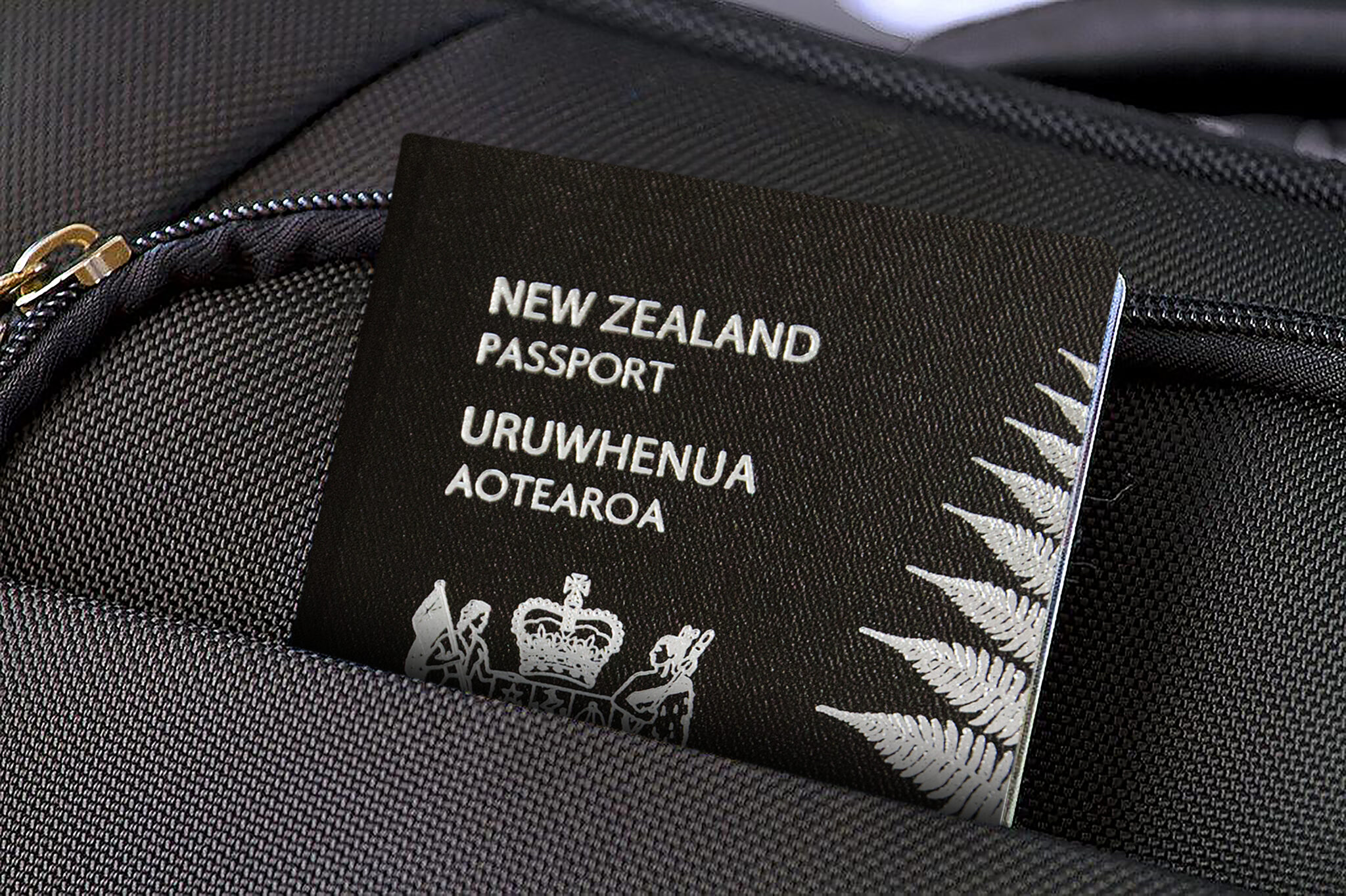 Close up of New Zealand Passport in Black Suitcase Pocket