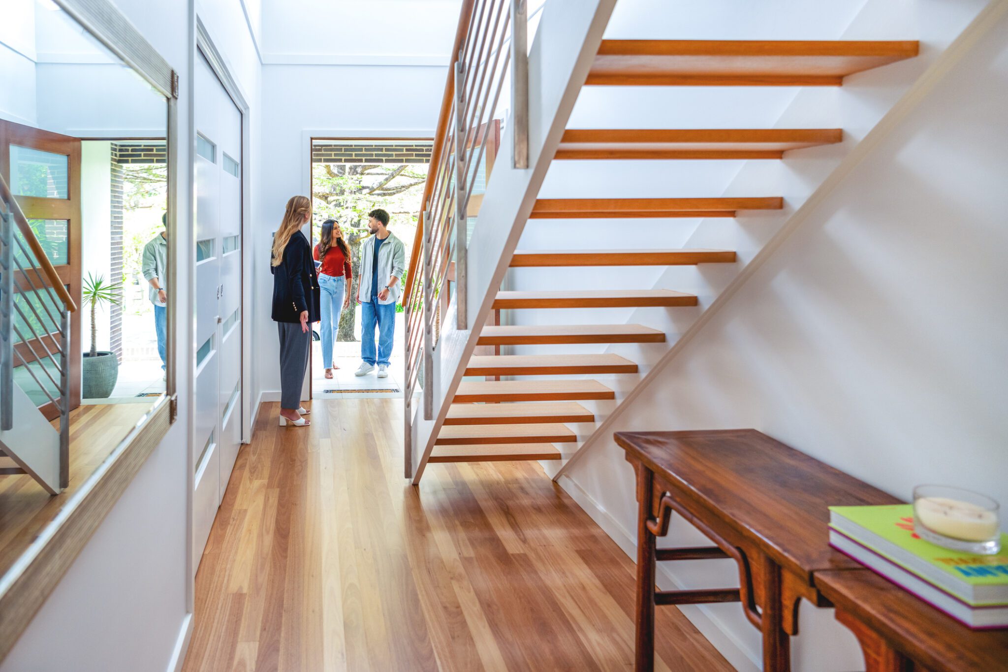 Real estate agent showing a young couple a new house.