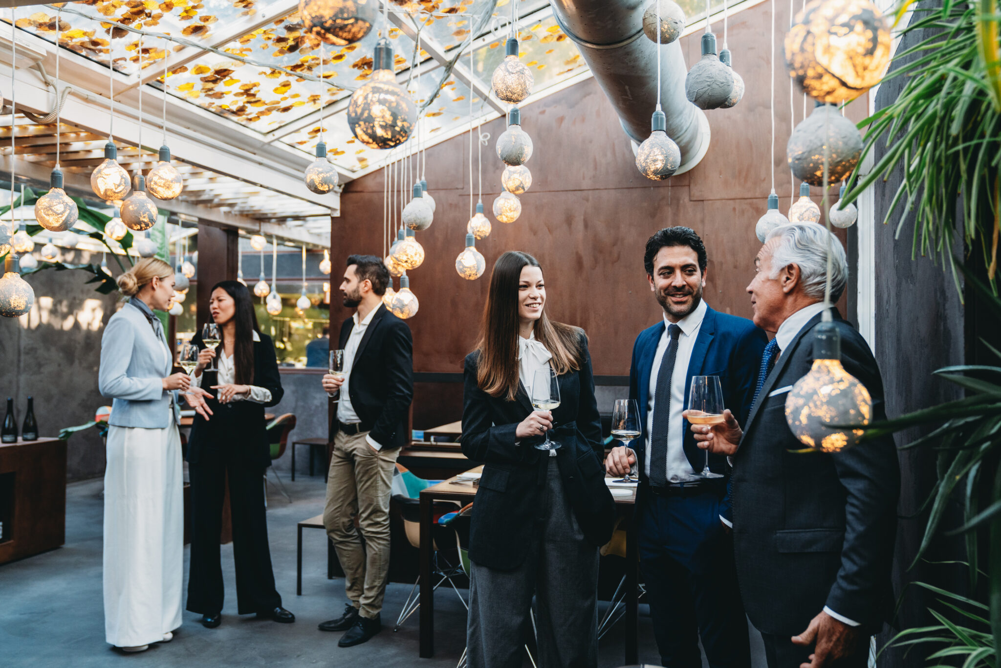 Business people are talking together during a teambuilding event in a luxury restaurant
