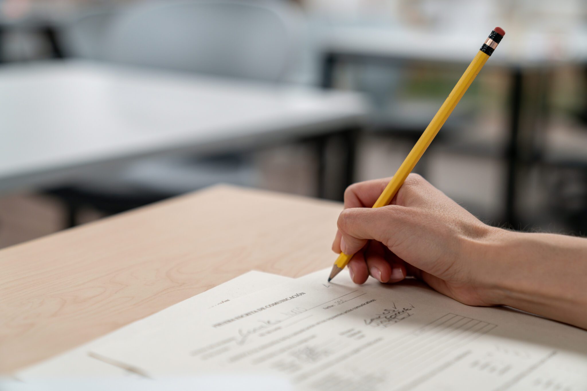 Close-up on a university teacher grading an exam