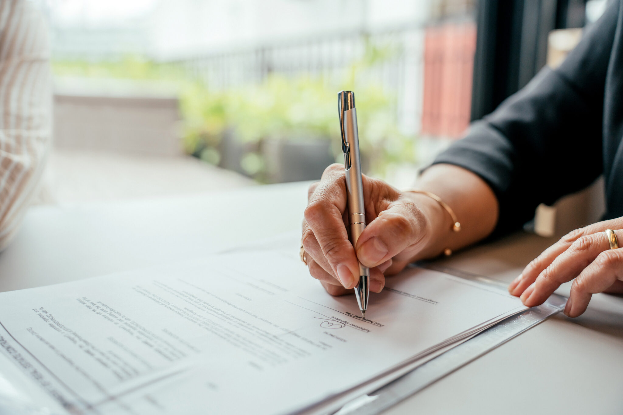 Detail of human hand signing contract