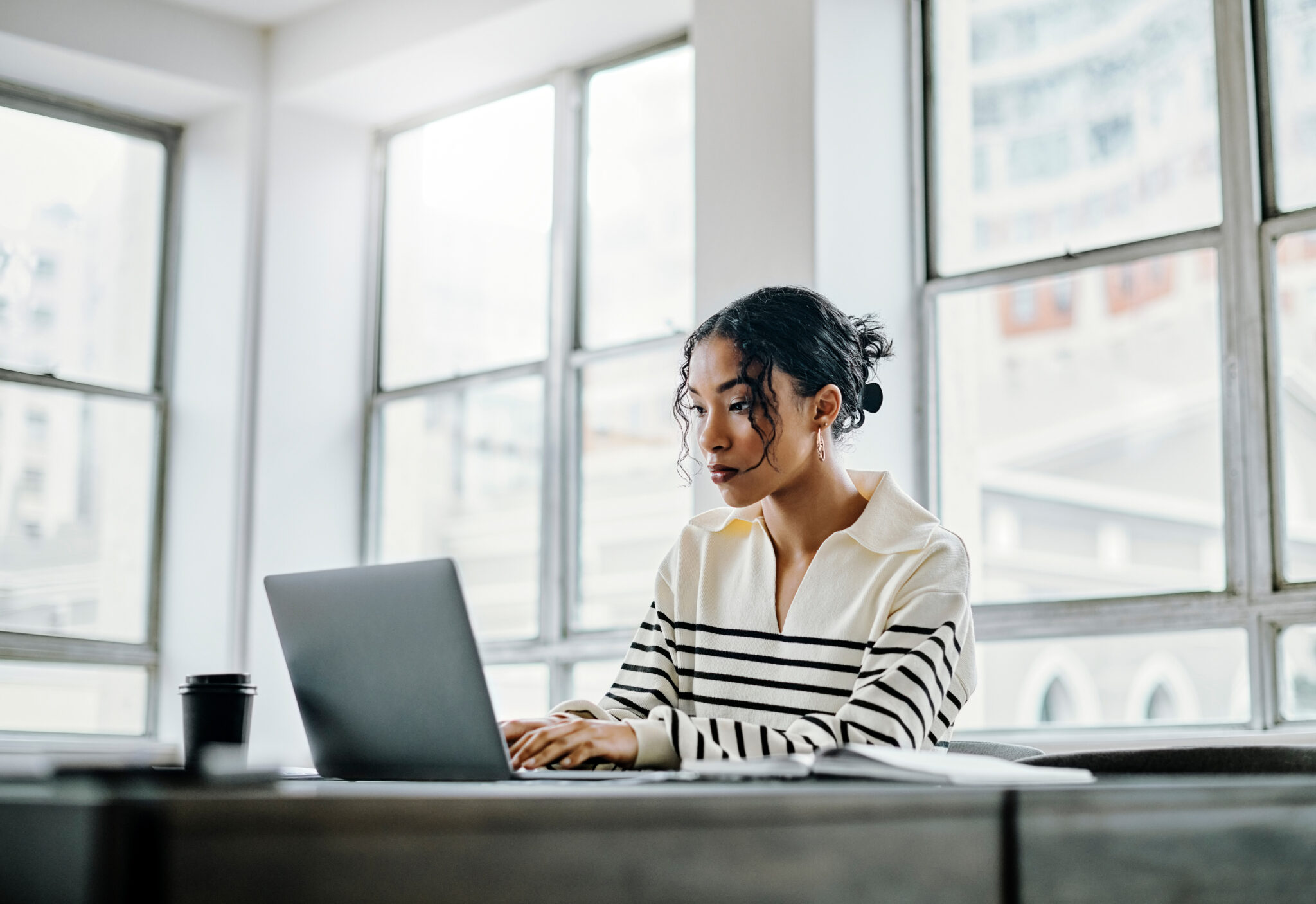 Business woman, laptop or typing email communication in digital marketing, advertising or networking company. Thinking creative worker, designer or entrepreneur on technology in brand growth planning