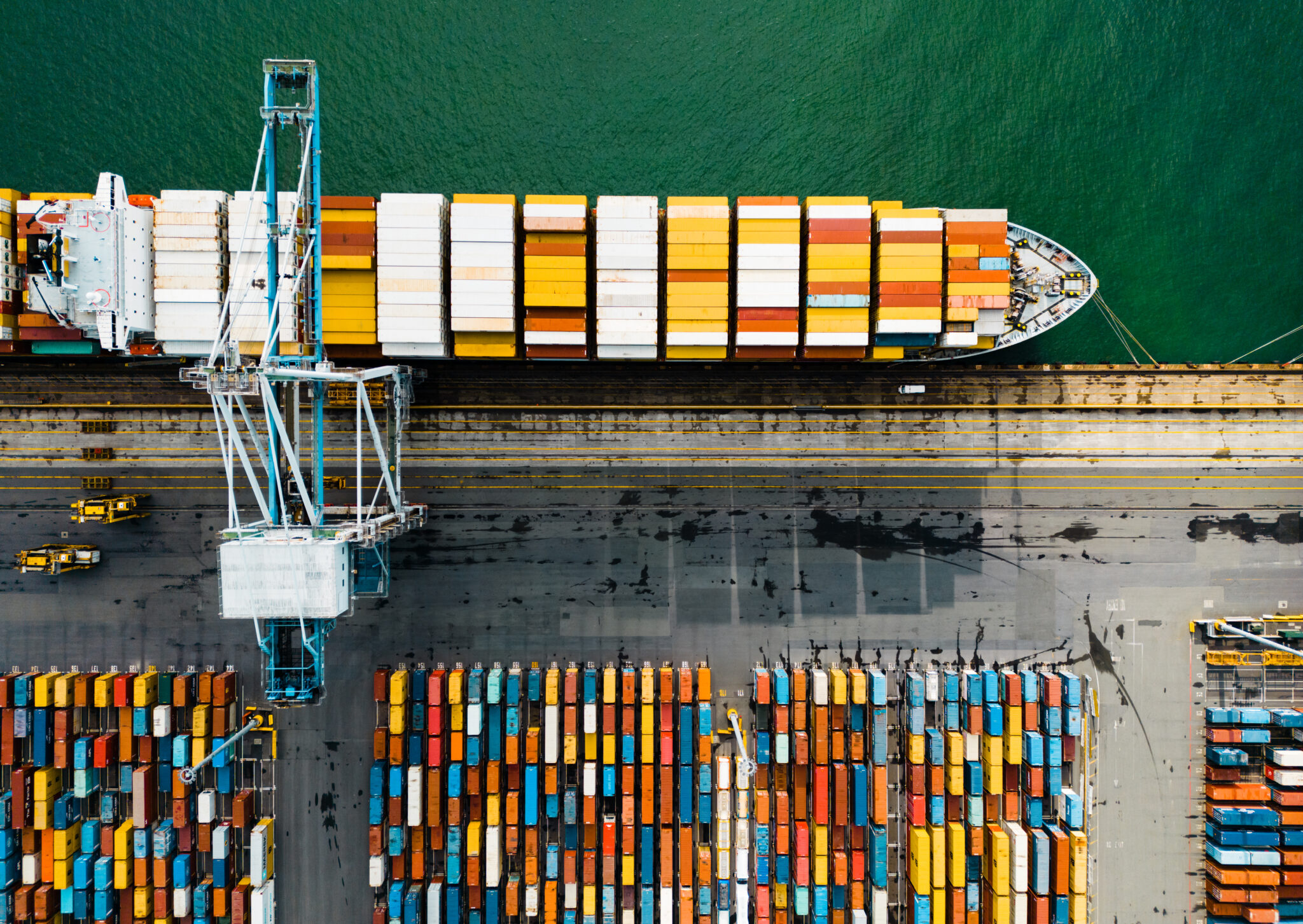 Aerial view industrial port with containers and container ship.